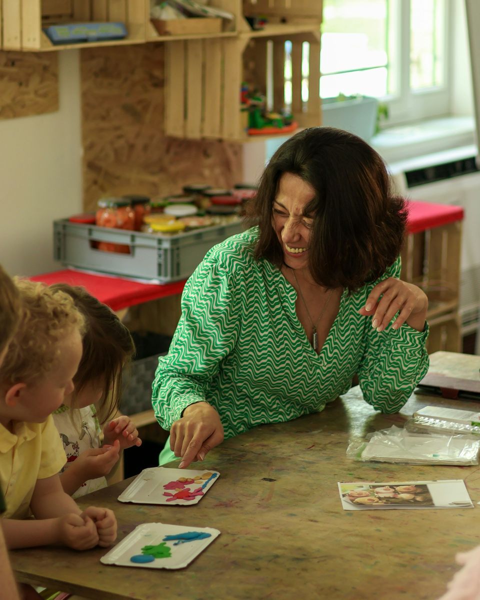 Preschool teacher doing a craft activity with children